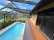 Screened-in pool area with a wooden deck and an open view to the water at 236 Cory St, Port Charlotte, FL 33953