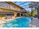 Screened pool with covered patio, lounge chairs, and lush landscaping at 236 Cory St, Port Charlotte, FL 33953