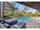 Enclosed pool with brick pavers, lounge chairs, and view of lush landscaping at 236 Cory St, Port Charlotte, FL 33953