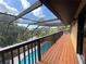 Screened-in deck overlooking a refreshing pool and lush backyard with mature trees at 236 Cory St, Port Charlotte, FL 33953