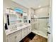 Elegant bathroom with double vanity, quartz countertop, stylish mirrors, and glass-enclosed shower at 236 Soliera St, Nokomis, FL 34275