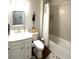 Standard bathroom with tile tub surround, white vanity and commode at 236 Soliera St, Nokomis, FL 34275