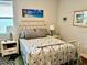 Charming bedroom with a white metal bed frame, two matching bedside tables, and neutral decor at 236 Soliera St, Nokomis, FL 34275