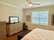 Bright bedroom features a large window, neutral colors, and classic furnishings at 236 Soliera St, Nokomis, FL 34275