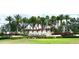 Beautiful Toscana Isles community entrance sign, showcasing lush landscaping, palm trees, and vibrant flowers at 236 Soliera St, Nokomis, FL 34275