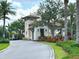 Charming community entrance with stone guardhouse, lush landscaping, and a secure gated entry at 236 Soliera St, Nokomis, FL 34275