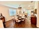 Bright dining room features wood floors and a round table set for six, plus a view into the adjacent living area at 236 Soliera St, Nokomis, FL 34275