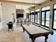 The game room offers a pool table, bar seating, and natural light from the surrounding windows at 236 Soliera St, Nokomis, FL 34275
