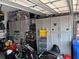 Organized garage with gray storage cabinets and a variety of tools and equipment at 236 Soliera St, Nokomis, FL 34275