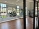 Modern gym with wood floors, glass walls, and lots of natural light at 236 Soliera St, Nokomis, FL 34275
