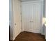 Hallway with wood floors and multiple white paneled doors, offering a clean and modern aesthetic at 236 Soliera St, Nokomis, FL 34275