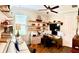 Comfortable home office with built-in shelves, a ceiling fan, and a well-lit workspace at 236 Soliera St, Nokomis, FL 34275