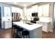 A kitchen with white cabinets, stainless steel appliances, and a large island with seating at 236 Soliera St, Nokomis, FL 34275