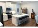 Spacious kitchen with a center island, seating, and stainless steel appliances at 236 Soliera St, Nokomis, FL 34275