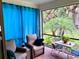 Relaxing screened lanai with comfortable seating and lush landscaping, ideal for outdoor enjoyment at 236 Soliera St, Nokomis, FL 34275