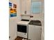 Laundry room with modern front load washer and dryer and storage cabinets at 236 Soliera St, Nokomis, FL 34275