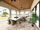 Covered outdoor lounge area with comfortable seating, ceiling fans, and views of the community pool and landscaping at 236 Soliera St, Nokomis, FL 34275