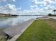 The waterfront has a wooden pier, lush grassy area, and canal views at 236 Soliera St, Nokomis, FL 34275