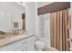 Bathroom featuring a vanity with granite counter, a toilet, and a shower with a curtain at 24849 Pennington Ter, Venice, FL 34293