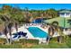 Aerial view of the community pool with palm trees, lounge chairs, and well-maintained landscaping at 24849 Pennington Ter, Venice, FL 34293