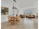 Open concept dining room flows to living room with neutral decor at 24849 Pennington Ter, Venice, FL 34293