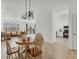 Open floorplan dining room with wood table and chairs and view of the living room at 24849 Pennington Ter, Venice, FL 34293
