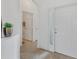 Bright entryway with tile flooring and a view of the hallway and doorway at 24849 Pennington Ter, Venice, FL 34293