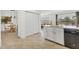 Open kitchen featuring white cabinets, quartz countertops, and stainless steel appliances with adjacent dining area at 24849 Pennington Ter, Venice, FL 34293