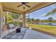 Relaxing screened-in lanai with comfortable seating, overlooking a tranquil lake view, perfect for outdoor living at 24849 Pennington Ter, Venice, FL 34293