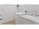Laundry room features washer, dryer, and wire shelving for ample storage at 24849 Pennington Ter, Venice, FL 34293