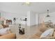 Bright and open living room featuring neutral tones, tile flooring, and seamless flow into the kitchen and dining area at 24849 Pennington Ter, Venice, FL 34293