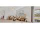 Comfortable living room offering neutral tones, tile flooring and window views at 24849 Pennington Ter, Venice, FL 34293