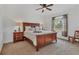 Cozy main bedroom with plush carpeting, natural light and side table lamps at 24849 Pennington Ter, Venice, FL 34293