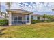 A screened-in patio features comfortable seating and a ceiling fan, perfect for outdoor living at 24849 Pennington Ter, Venice, FL 34293
