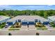 Aerial view of a well-maintained residential property with multiple units, garages, and landscaped surroundings at 25069 Pearl Lake Cir, Englewood, FL 34223