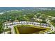 Aerial view of new community with a lake, landscaping, and modern homes at 25069 Pearl Lake Cir, Englewood, FL 34223
