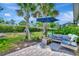 Cozy patio area with stylish outdoor furniture and a sun umbrella for enjoying the outdoors at 25069 Pearl Lake Cir, Englewood, FL 34223
