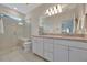 Modern bathroom features double sinks, large mirror, and glass-enclosed shower with bench seating at 25069 Pearl Lake Cir, Englewood, FL 34223