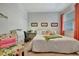 Cozy bedroom has a workspace, ceiling fan, natural light, and colorful decor at 25069 Pearl Lake Cir, Englewood, FL 34223