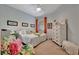 Comfortable bedroom features a ceiling fan, natural light, and colorful accents at 25069 Pearl Lake Cir, Englewood, FL 34223