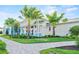 A refined clubhouse and its manicured lawn create an inviting space for recreation and enjoyment at 25069 Pearl Lake Cir, Englewood, FL 34223