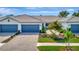 Charming single-story home with well-maintained landscaping and a brick driveway, perfect for easy living at 25069 Pearl Lake Cir, Englewood, FL 34223