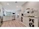 Bright, open kitchen flows into a living space, complemented by wood floors and modern decor at 25069 Pearl Lake Cir, Englewood, FL 34223