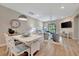 Inviting living space with dining area, and lots of light streaming through the sliding glass doors at 25069 Pearl Lake Cir, Englewood, FL 34223