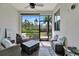 Screened patio features comfortable wicker furniture and a view of tropical landscaping at 25069 Pearl Lake Cir, Englewood, FL 34223