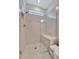 Bright, tiled shower features a built-in bench, glass enclosure, and decorative accent tiles at 25069 Pearl Lake Cir, Englewood, FL 34223