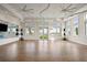 Bright and airy studio with hardwood floors, ceiling fans, mirrors, and large windows offering natural light at 25069 Pearl Lake Cir, Englewood, FL 34223