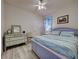 Charming bedroom showcasing a coordinated design, dresser, and wood-look tile flooring at 25784 Grayton Ave, Englewood, FL 34223