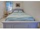 Comfortable bedroom featuring blue accents, nautical bedding, and a serene, relaxing ambiance at 25784 Grayton Ave, Englewood, FL 34223
