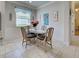 Cozy dining nook features a glass table, comfortable seating, and bright window at 25784 Grayton Ave, Englewood, FL 34223